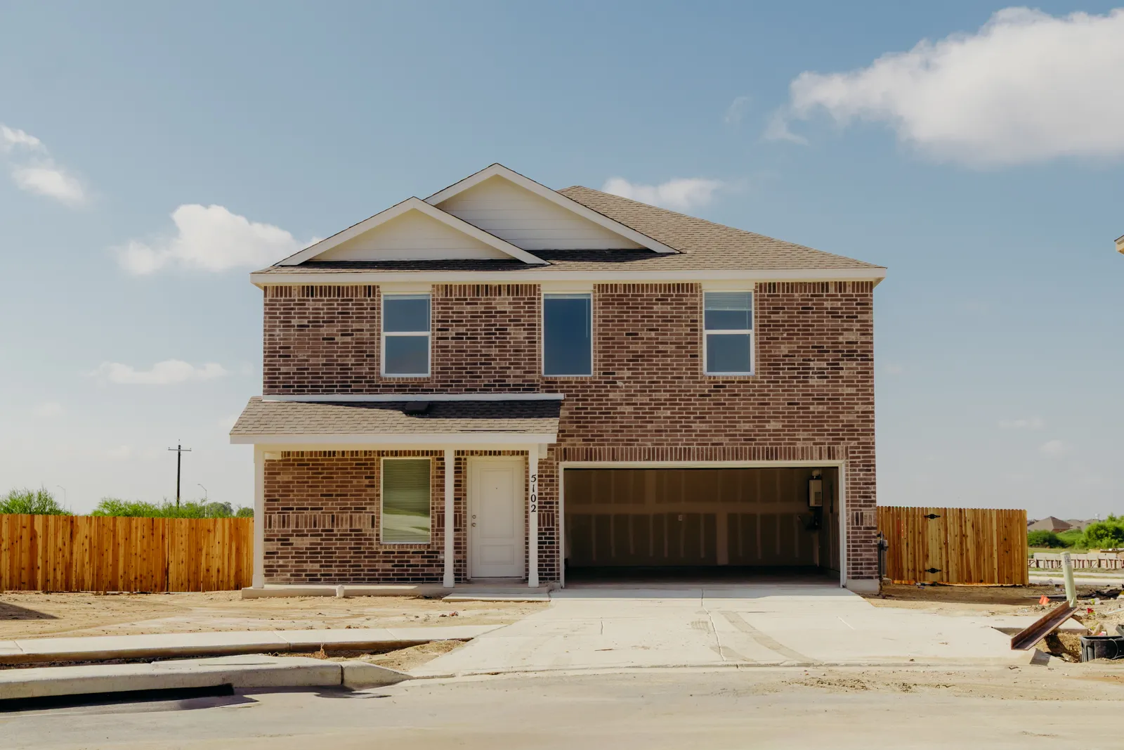 Finished two-story brick house with an open garage